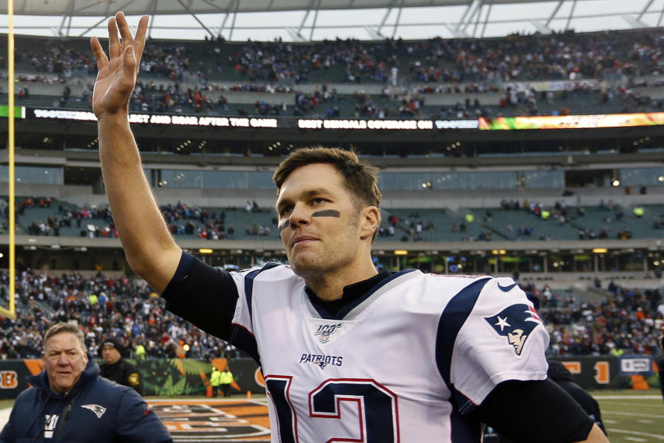 FILE - In this Dec. 15, 2019, file photo, New England Patriots quarterback Tom Brady waves to the crowd after an NFL football game against the Cincinnati Bengals in Cincinnati. The Miami Dolphins signed seven potential starters, but none will help their chances of overtaking the New England Patriots in the AFC East as much as Tom Brady did by bolting from Boston for Tampa Bay. (AP Photo/Frank Victores, File)