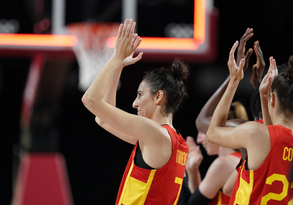 Spain's Alba Torrens (7), left, and teammates celebrate their win in the women's basketball preliminary round game against Canada at the 2020 Summer Olympics, Sunday, Aug. 1, 2021, in Saitama, Japan. (AP Photo/Charlie Neibergall)