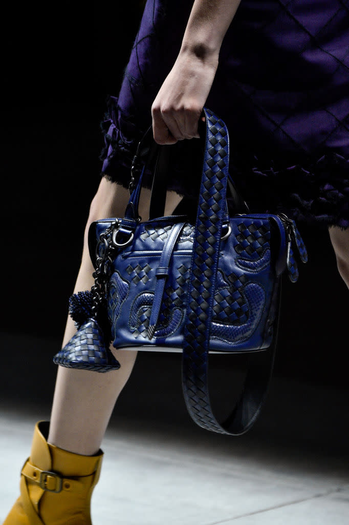 <p>A model carries a blue woven bag from the Bottega Veneta FW18 show. (Photo: Getty Images) </p>