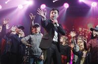 FILE In this file photo taken on Friday, March 29, 2019, Volodymyr Zelenskiy, Ukrainian actor and candidate in the upcoming presidential election, hosts a comedy show at a concert hall in Brovary, Ukraine. For his presidential campaign popular Ukrainian comedian Volodymyr Zelenskiy has literally taken the script from a TV show in which he plays the Ukrainian president. (AP Photo/Efrem Lukatsky, File)