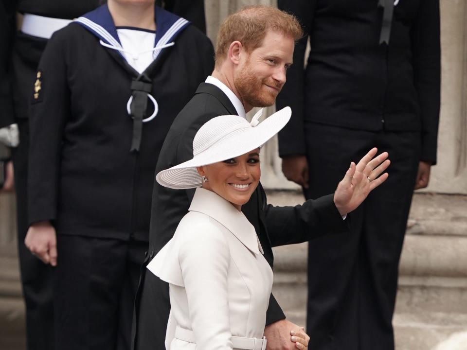 Prince Harry and Meghan Markle walking up the steps of St Paul's Cathedral.