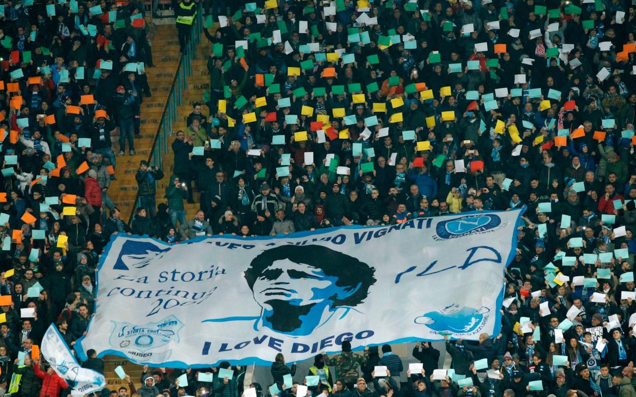 Napoli's fans deploy a giant banner showing Argentinian football star Diego Maradona before the Italian Serie A football match Napoli vs Juventus - CARLO HERMANN/AFP