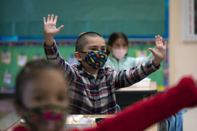 FILE - In this April 13, 2021, file photo, kindergarten students participate in a classroom activity on the first day of in-person learning at Maurice Sendak Elementary School in Los Angeles. California will require that masks be worn at schools when classrooms open this fall. California Health and Human Services Secretary Dr. Mark Ghaly said, Friday July 9, 2021, that not all schools can accommodate physical distancing of at least 3-feet or more, so the best preventative measure is indoor masking. (AP Photo/Jae C. Hong, File)