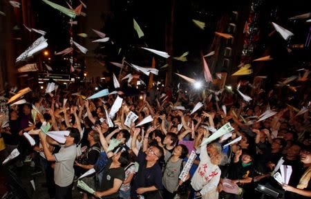 Hundreds of protesters throw paper planes outside the Legislative Council in Hong Kong, July 13, 2011. A contentious bill to scrap the mechanism for Legislative Council by-elections triggered several days of protests outside the council building. Hundreds of demonstrators threw paper planes with political messages at the building. REUTERS/Bobby Yip/File photo