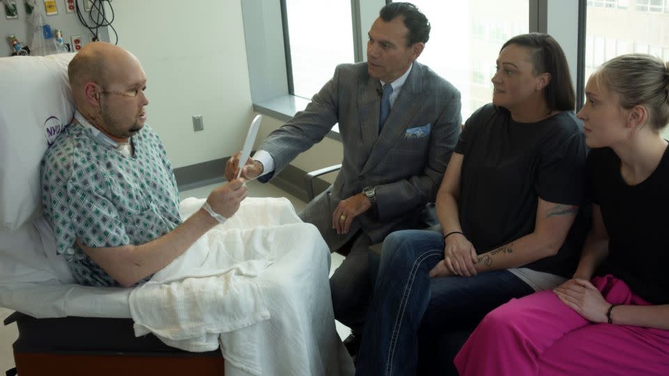 Aaron James sees his new face for the first time with Dr. Eduardo Rodriguez, wife Meagan and daughter Allie, - NYU Langone Health