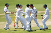 Dale Steyn of South Africa celebrates with teammates after getting the wicket of David Warner of Australia (L) during day one of the First Test match between South Africa and Australia on February 12, 2014 in Centurion, South Africa. (Photo by Morne de Klerk/Getty Images)