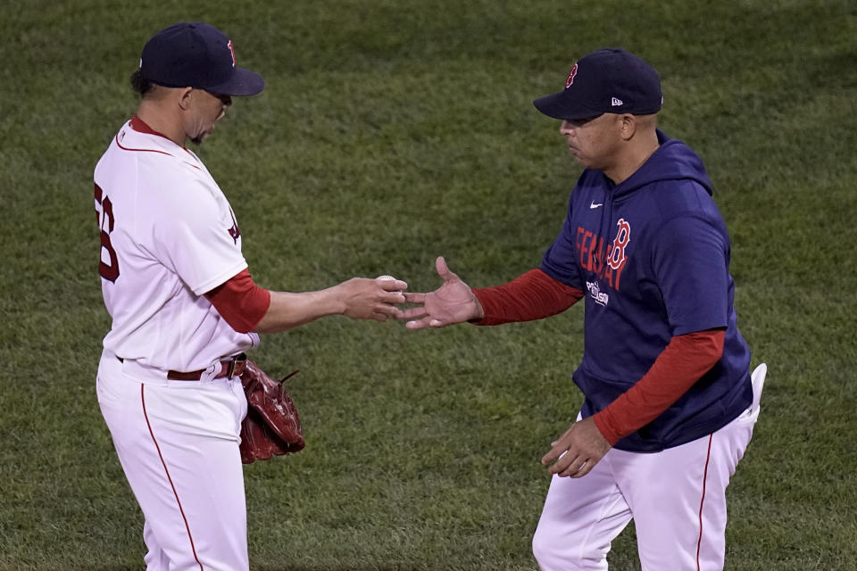 Boston Red Sox relief pitcher Hansel Robles is taken out of the game by manager Alex Cora during the seventh inning in Game 5 of baseball's American League Championship Series against the Houston Astros Wednesday, Oct. 20, 2021, in Boston. (AP Photo/Charles Krupa)