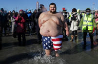 <p>Polar Bear Club swimmers make their annual icy plunge into the Atlantic Ocean on New Year’s Day, January 1, 2018, at Coney Island in the Brooklyn borough of New York City. (Photo: Yana Paskova/Getty Images) </p>