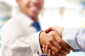 Closeup of a business handshake, isolated on white