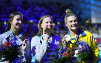 Silver medalist Jenna Strauch of Australia, right, gold medalist Lilly King of the United States, centre, bronze medalist Kate Douglass of the United States, left, pose with their medals after the Women 200m Breaststroke final at the 19th FINA World Championships in Budapest, Hungary, Thursday, June 23, 2022. (AP Photo/Petr David Josek)