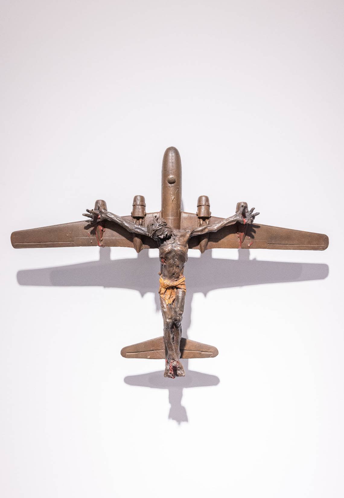 San Francisco artist Al Farrow critiques the use of religion to justify war in his artwork. In this sculpture, Christ is depicted on a fighter jet.