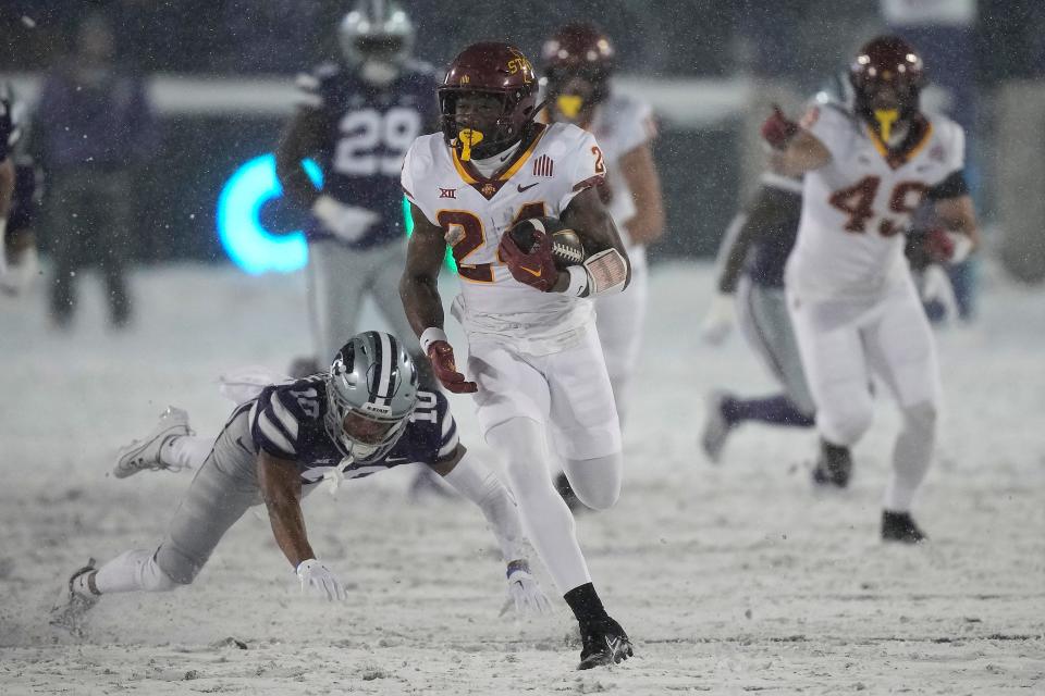 Kansas State running back Abu Sama (24) eludes a lunging Jacob Parrish (10) of Kansas State on the way to a 71-yard touchdown Saturday night at Bill Snyder Family Stadium.