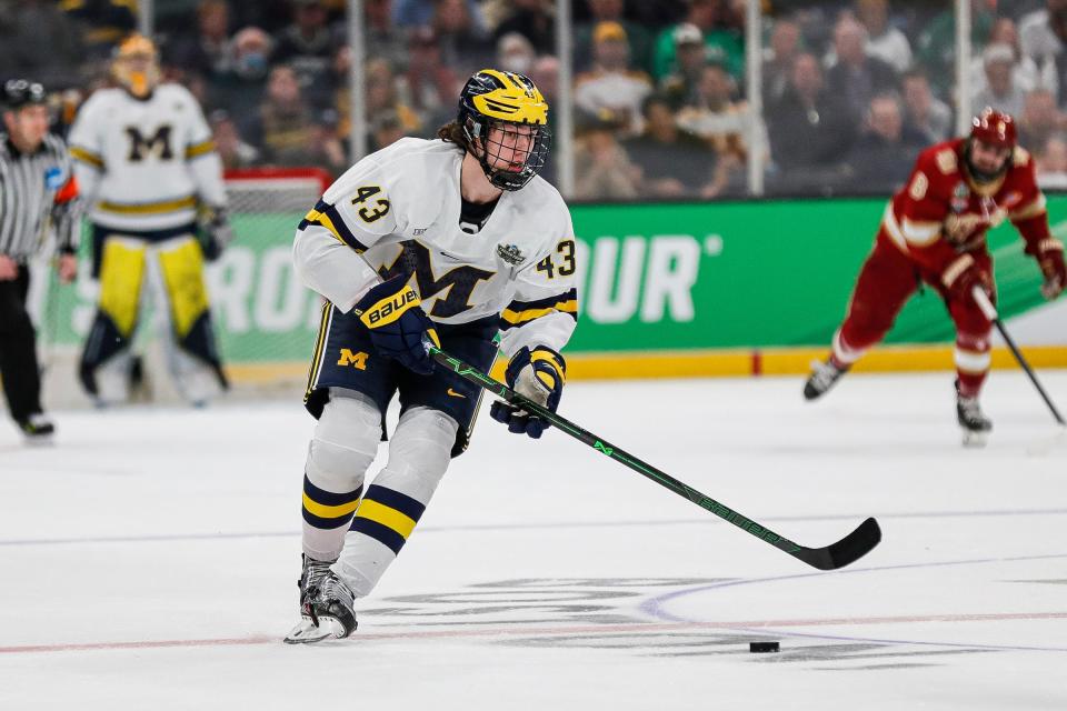 Michigan defenseman Luke Hughes (43) looks to pass against Denver during the first period of the Frozen Four semifinal at the TD Garden in Boston, Mass. on Thursday., April 7, 2022.