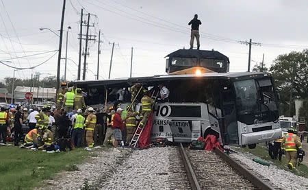Biloxi firefighters help passengers escape the wreckage after a train travelling from Austin, Texas, collided with a charter bus in Biloxi, Mississippi, U.S., March 7, 2017. REUTERS/John Fitzhugh/Biloxi SunHerald