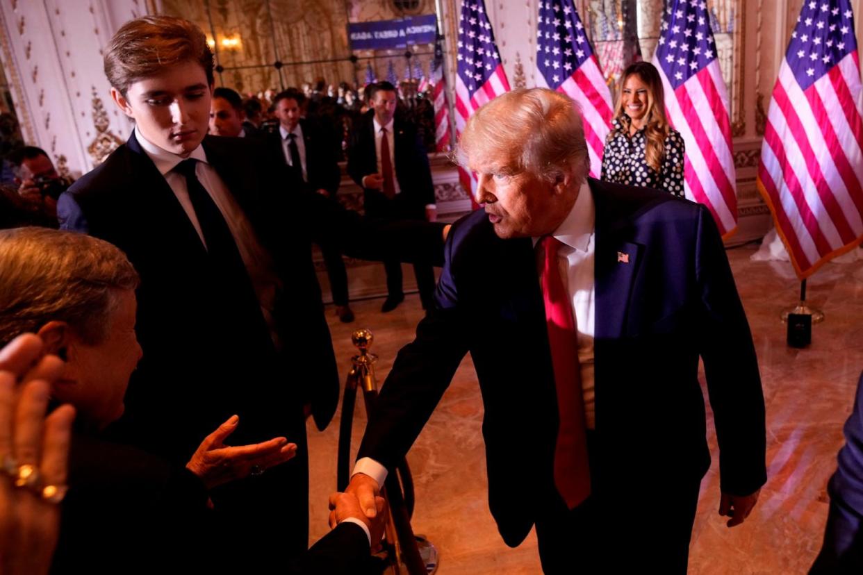PHOTO: In this Nov. 15, 2022, file photo, former President Donald Trump greets people after announcing he is running for president for the third time as he speaks at Mar-a-Lago, in Palm Beach, Fla. Son Barron Trump watches.  (Andrew Harnik/AP, FILE)