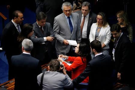 Jurist Janaina Paschoal (C), co-author of the complaint that originated the impeachment process against suspended president Dilma Rousseff, speaks with senators during the final session of debate and voting on Rousseff's impeachment trial in Brasilia, Brazil August 26, 2016. REUTERS/Ueslei Marcelino