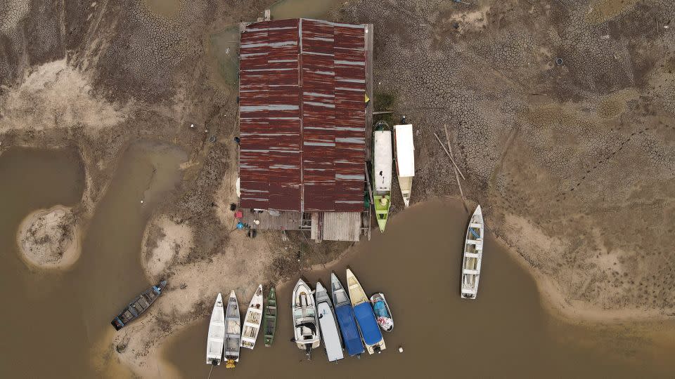 Boats and houseboats stranded in a dry area of the Igarape do Taruma stream which flows into the Rio Negro river in Brazil's Amazon rainforest, Oct 16, 2023.  - Bruno Kelly/Reuters