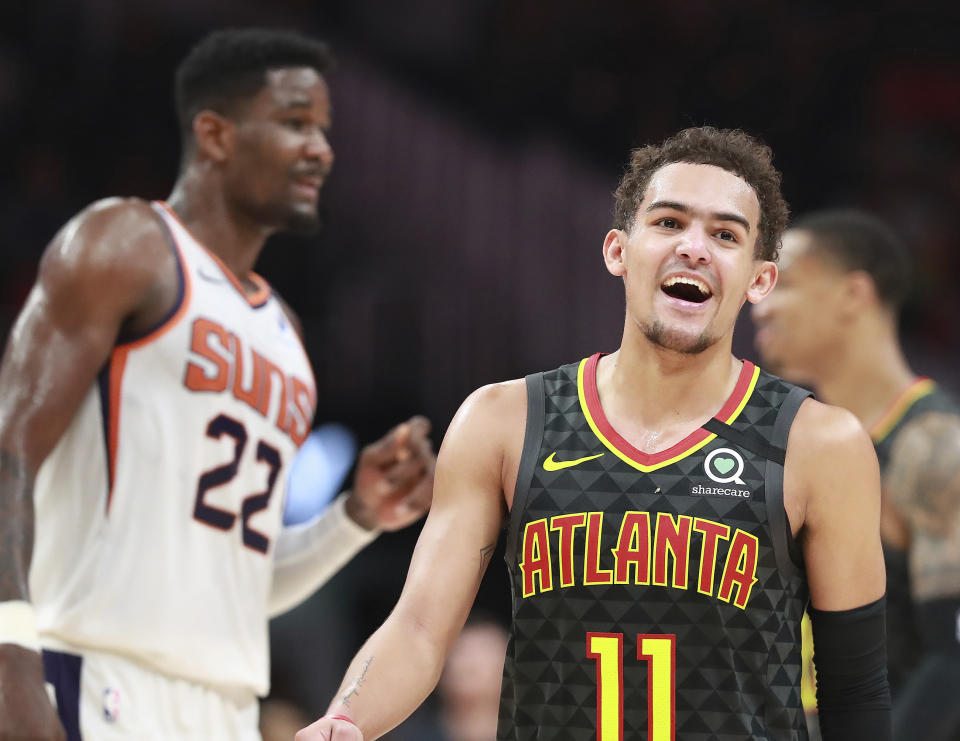 Atlanta Hawks guard Trae Young is all smiles during the final minutes of a 123-110 victory over Deandre Ayton and the Phoenix Suns in an NBA basketball game on Tuesday, Jan. 14, 2020, in Atlanta. (Curtis Compton/Atlanta Journal-Constitution via AP)