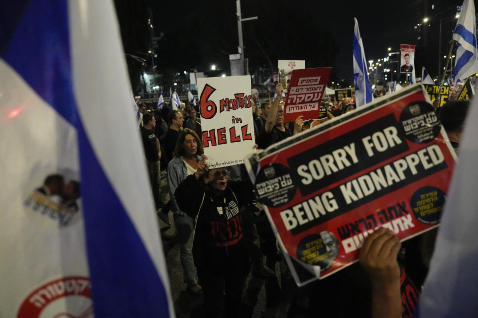 People take part in a protest against Israeli Prime Minister Benjamin Netanyahu's government and call for the release of hostages held in the Gaza Strip by the Hamas militant group, in Tel Aviv, Israel, Saturday, April 6, 2024. (AP Photo/Ariel Schalit)