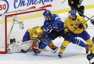 Finland's Rasmus Ristolainen (C) scores the game winning goal on Sweden's goalie Oscar Dansk (L) and Robin Norell during overtime of their IIHF World Junior Championship gold medal ice hockey game in Malmo, Sweden, January 5, 2014. REUTERS/Alexander Demianchuk (SWEDEN - Tags: SPORT ICE HOCKEY)