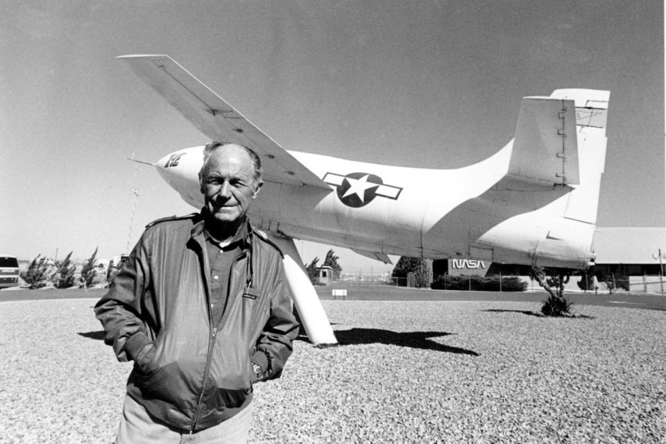 Posing in front of the rocket-powered plane that he flew to record speeds in 1947, Chuck Yeager is seen at Edwards Air Force Base on Sept. 4, 1985.