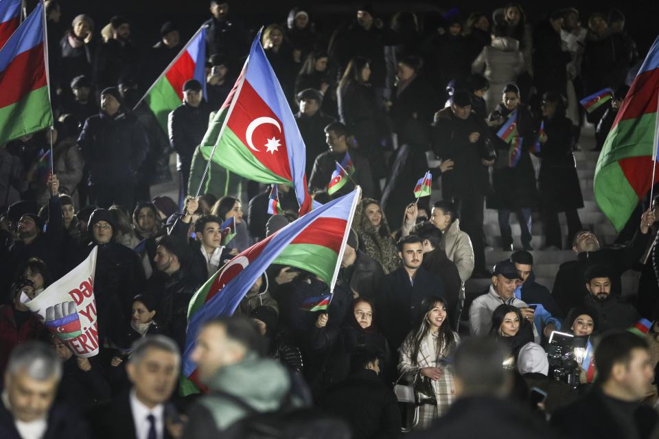 People wave national flags celebrating Azerbaijan's President Ilhan Aliyev's victory in the presidential election in Baku, Azerbaijan, Wednesday, Feb. 7, 2024. Azerbaijanis voted Wednesday in an election almost certain to see incumbent President Ilhan Aliyev chosen to serve another seven-year term. (AP Photo)