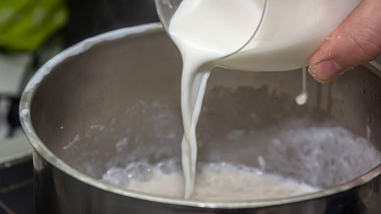 milk pouring into pot