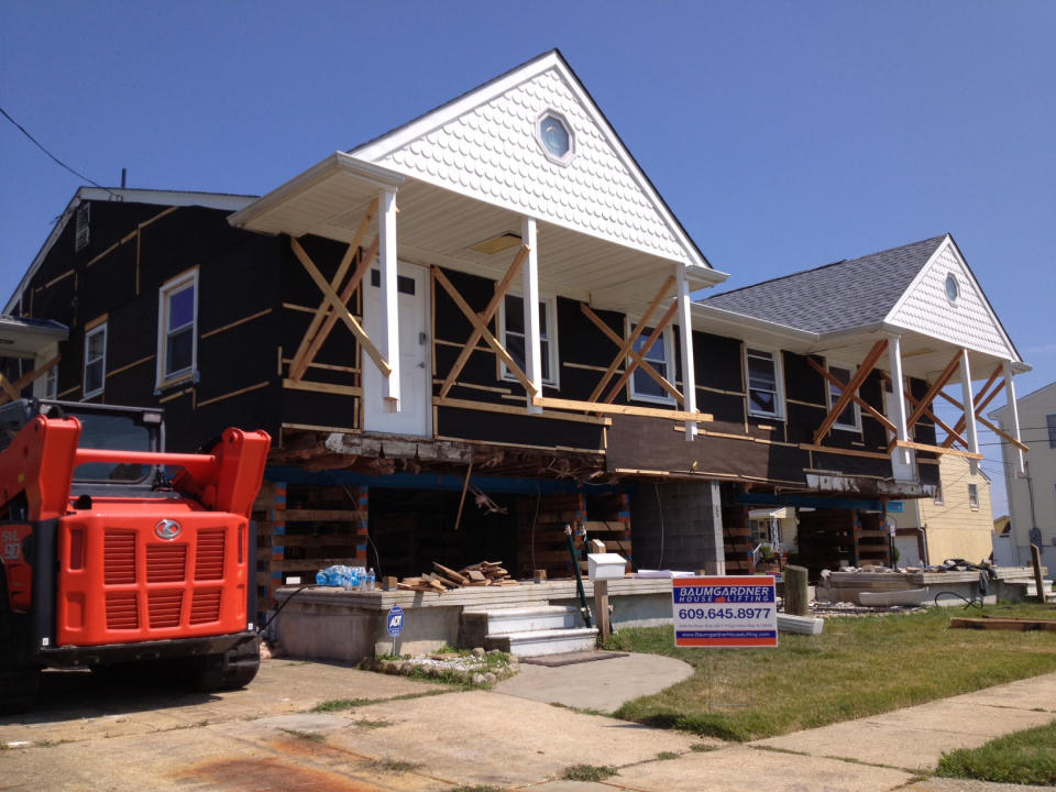 This Aug. 2013 photo provided by L & R Resources, LLC shows Eileen Benner’s Atlantic City home in the process of being elevated after it suffered severe flood damage during Oct. 2012 Superstorm Sandy, in New Jersey. Roderick Scott of L&R Resources in Mandeville, La., says he recommends that homes be lifted 1 or 2 feet above the minimum needed to get a flood elevation certificate. (AP Photo/L & R Resources, LLC, Roderick Scott)