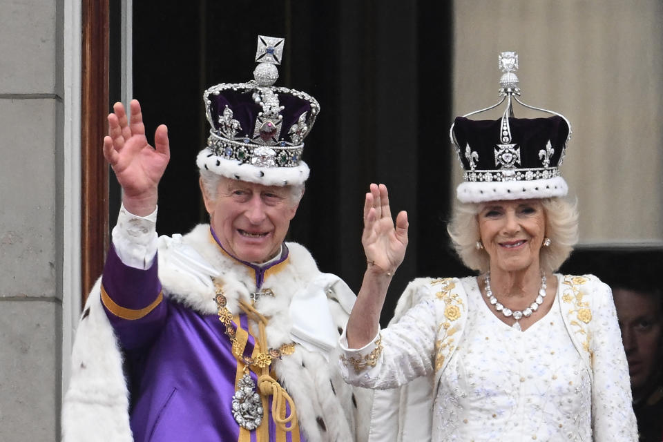 Britain's King Charles III wearing the Imperial state Crown, and Britain's Queen Camilla wearing a modified version of Queen Mary's Crown wave from the Buckingham Palace balcony after viewing the Royal Air Force fly-past in central London on May 6, 2023, after their coronations. - The set-piece coronation is the first in Britain in 70 years, and only the second in history to be televised. Charles will be the 40th reigning monarch to be crowned at the central London church since King William I in 1066. (Photo by Marco BERTORELLO / AFP) (Photo by MARCO BERTORELLO/AFP via Getty Images)
