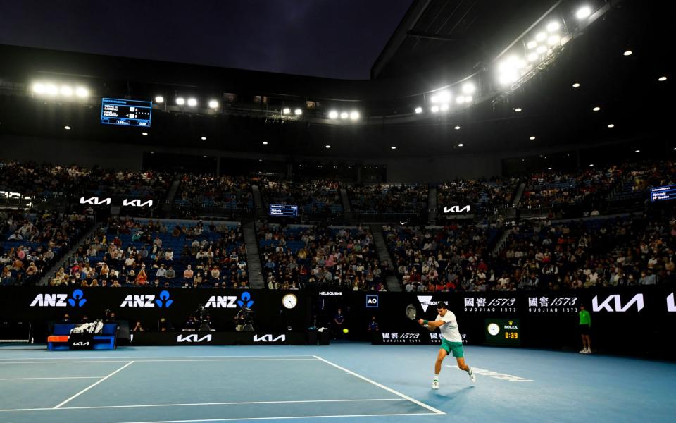 A regular sight - Djokovic playing under the lights on the final day of the Aussie Open - Shutterstock