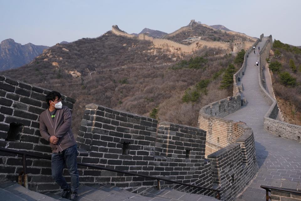 A tourist wearing a protective face mask visits the Badaling Great Wall after it was re-opened on March 24, 2020 in Beijing, China.