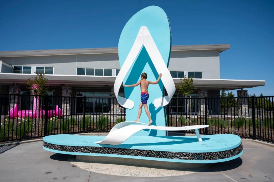 Graham Johnson, 9, plays on giant flip-flops, during the official grand opening of the North Natomas Community Center and Aquatics Complex in Sacramento on Saturday, April 23, 2022.