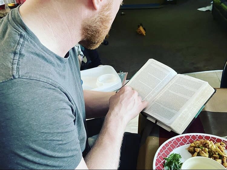 Photo of man reading a book (the Bible) (@carlyfriesen4 / Instagram)