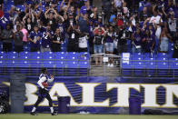 Baltimore Ravens' Marlon Humphreys looks to fans before throwing an autographed football, after practice at NFL football training camp Saturday, July 31, 2021, in Baltimore. (AP Photo/Gail Burton)