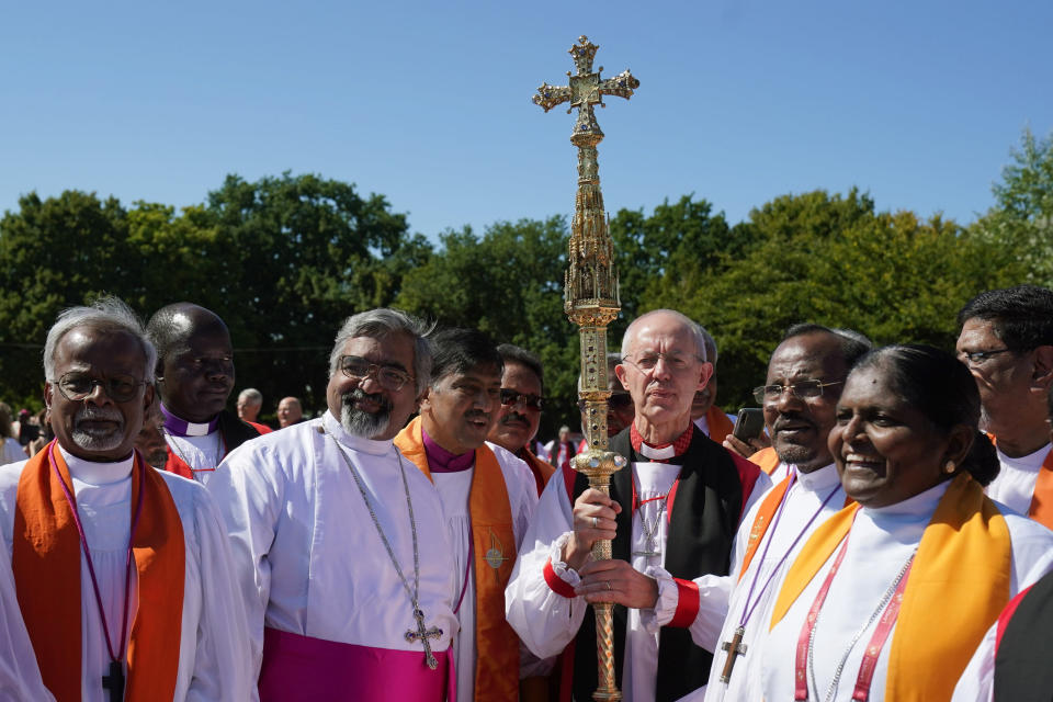 FILE - Archbishop of Canterbury Justin Welby, center right and bishops from around the world gather at the University of Kent for a group photo during the 15th Lambeth Conference, in Canterbury, England, Friday, July 29, 2022. Friction has been simmering within the global Anglican Communion for many years over its 42 provinces’ sharp differences on whether to recognize same-sex marriage and ordain LGBTQ clergy. In 2022, the divisions have widened, as conservative bishops – notably from Africa and Asia – affirmed their opposition to LGBTQ inclusion and demanded “repentance” by the more liberal provinces with inclusive policies. (Gareth Fuller/PA via AP, File)