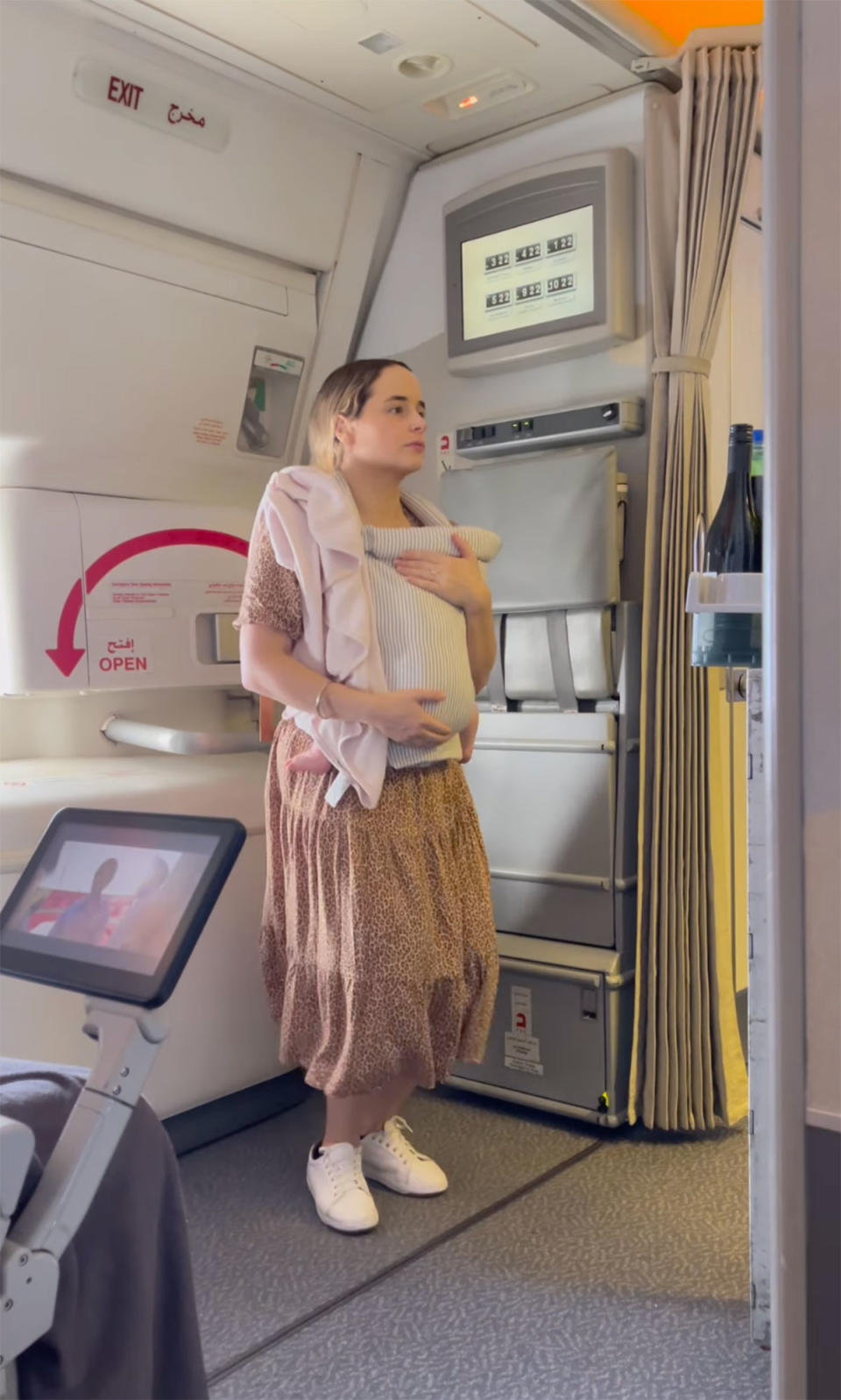 Woman rocking her baby to sleep on plane