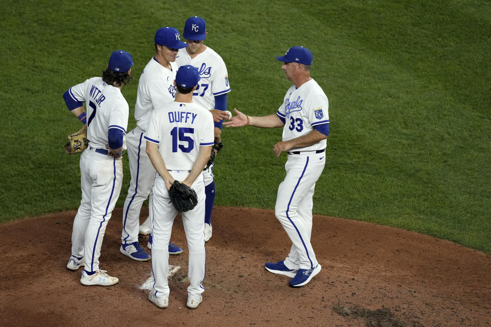 Kansas City Royals manager Matt Quatraro (33) takes the ball from starting pitcher Zack Greinke to make a pitching change during the fifth inning of a baseball game against the Pittsburgh Pirates Monday, Aug. 28, 2023, in Kansas City, Mo. (AP Photo/Charlie Riedel)