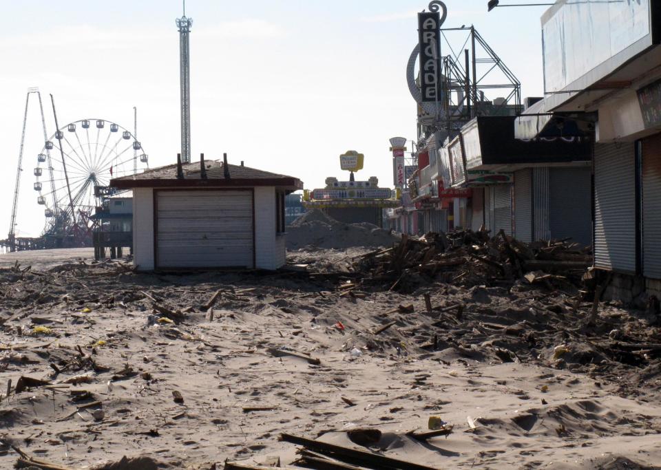 In this Nov. 29, 2012 photo, sand and rubble sit where the boardwalk used to be in Seaside Heights N.J. Seaside Heights, like many other coastal towns, is racing to rebuild its boardwalk from Superstorm Sandy's damage in time for next summer's tourism season. (AP Photo/Wayne Parry)