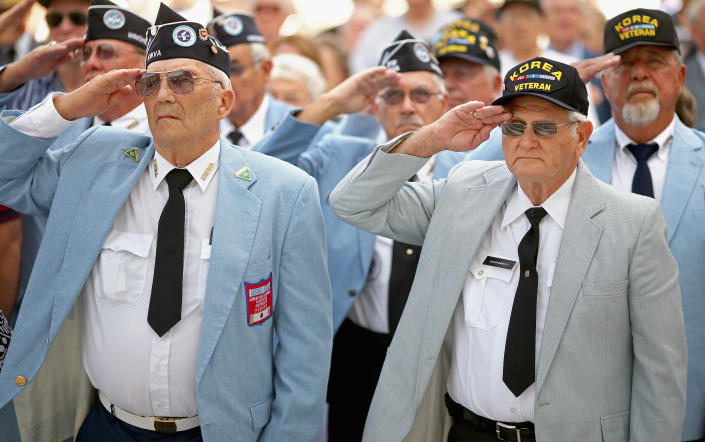Veterans of the Korean War salute during the commemoration of the 59th anniversary of the Korean War Armistice at Arlington National Cemetery July 27, 2012 in Arlington, Virginia. Hundreds of Korean war veterans attended the commemoration of the armistice agreement that ended more than three years of fighting between the United Nations, the People's Republic of China, North Korea and South Korea. (Photo by Chip Somodevilla/Getty Images)