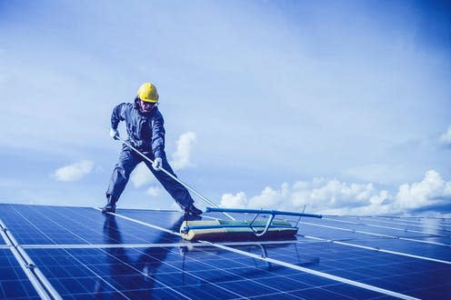 <span class="caption">Covering roofs with solar panels could significantly contribute to decarbonising global energy systems.</span> <span class="attribution"><a class="link " href="https://pixabay.com/photos/man-solar-panel-rooftop-cleaning-5680696/" rel="nofollow noopener" target="_blank" data-ylk="slk:MaddyBris/Pixabay;elm:context_link;itc:0;sec:content-canvas">MaddyBris/Pixabay</a></span>