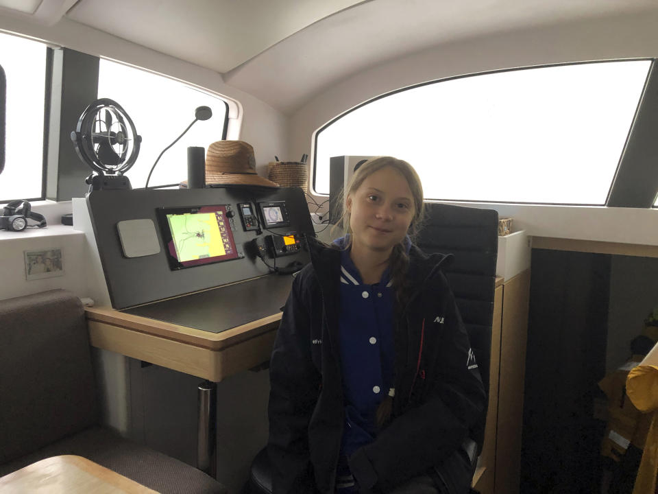 Greta Thunberg, a 16-year-old climate activist from Sweden, sits on a catamaran docked in Hampton, Va., on Tuesday, Nov. 12, 2019. Thunberg will leave North America and begin her return trip across the Atlantic on Wednesday aboard a 48-foot (15-meter) catamaran sailboat whose passengers include an 11-month-old baby. The boat leaves little to no carbon footprint, boasting solar panels and a hydro-generators for power. (AP Photo/Ben Finley)