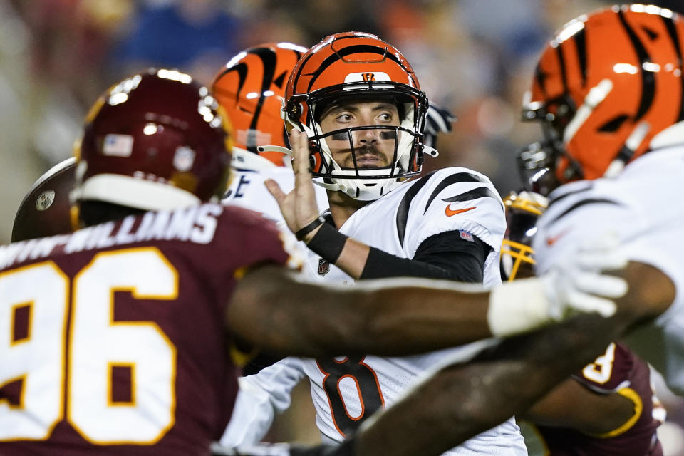 Cincinnati Bengals quarterback Brandon Allen (8) looks to pass under pressure from Washington Football Team defensive end James Smith-Williams (96) during the first half of a preseason NFL football game Friday, Aug. 20, 2021, in Landover, Md. (AP Photo/Susan Walsh)