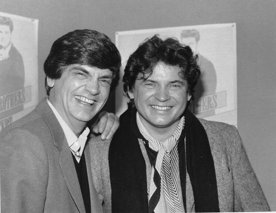 FILE - In this Jan. 4, 1984 file photo, Phil, left, and Don Everly, of the Everly Brothers joke around for photographers in New York City. Everly, who with his brother Don formed an influential harmony duo that touched the hearts and sparked the imaginations of rock 'n' roll singers for decades, including the Beatles and Bob Dylan, died Friday, Jan. 3, 2014. He was 74. Everly died of chronic obstructive pulmonary disease at a Burbank hospital, said his son Jason Everly. (AP Photo/Ray Stubblebine, File)