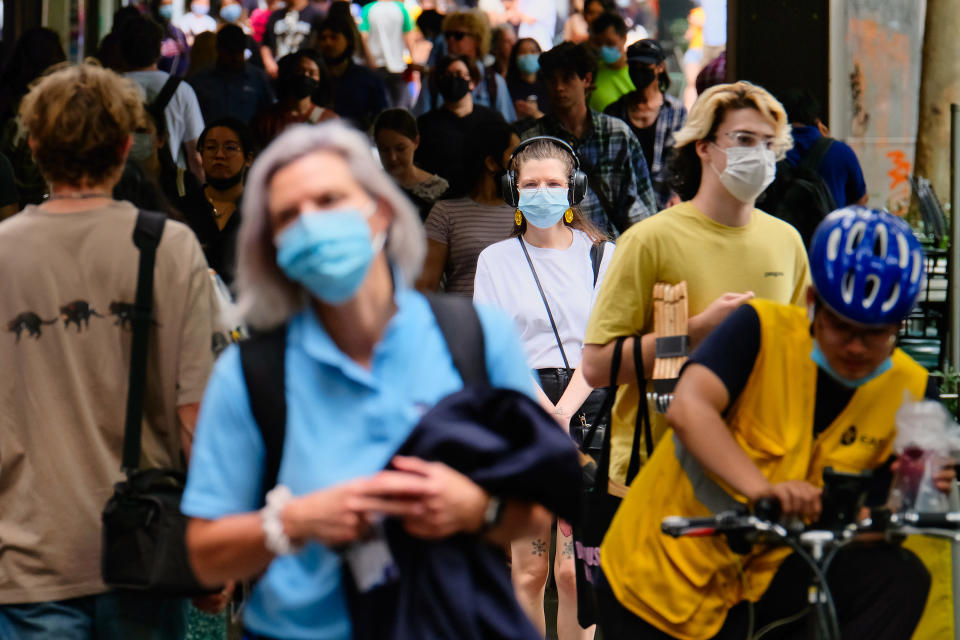 MELBOURNE, AUSTRALIA - FEBRUARY 11: Pedestrians wearing masks walk past the Pullman Hotel on February 11, 2021 in Melbourne, Australia. Victorians have been warned to remain on alert for coronavirus symptoms following new COVID-19 cases detected in the community linked to the Holiday Inn quarantine hotel. Residents were relocated to the Pullman Hotel and the Holiday Inn was closed for deep cleaning on Wednesday. (Photo by Luis Ascui/Getty Images)