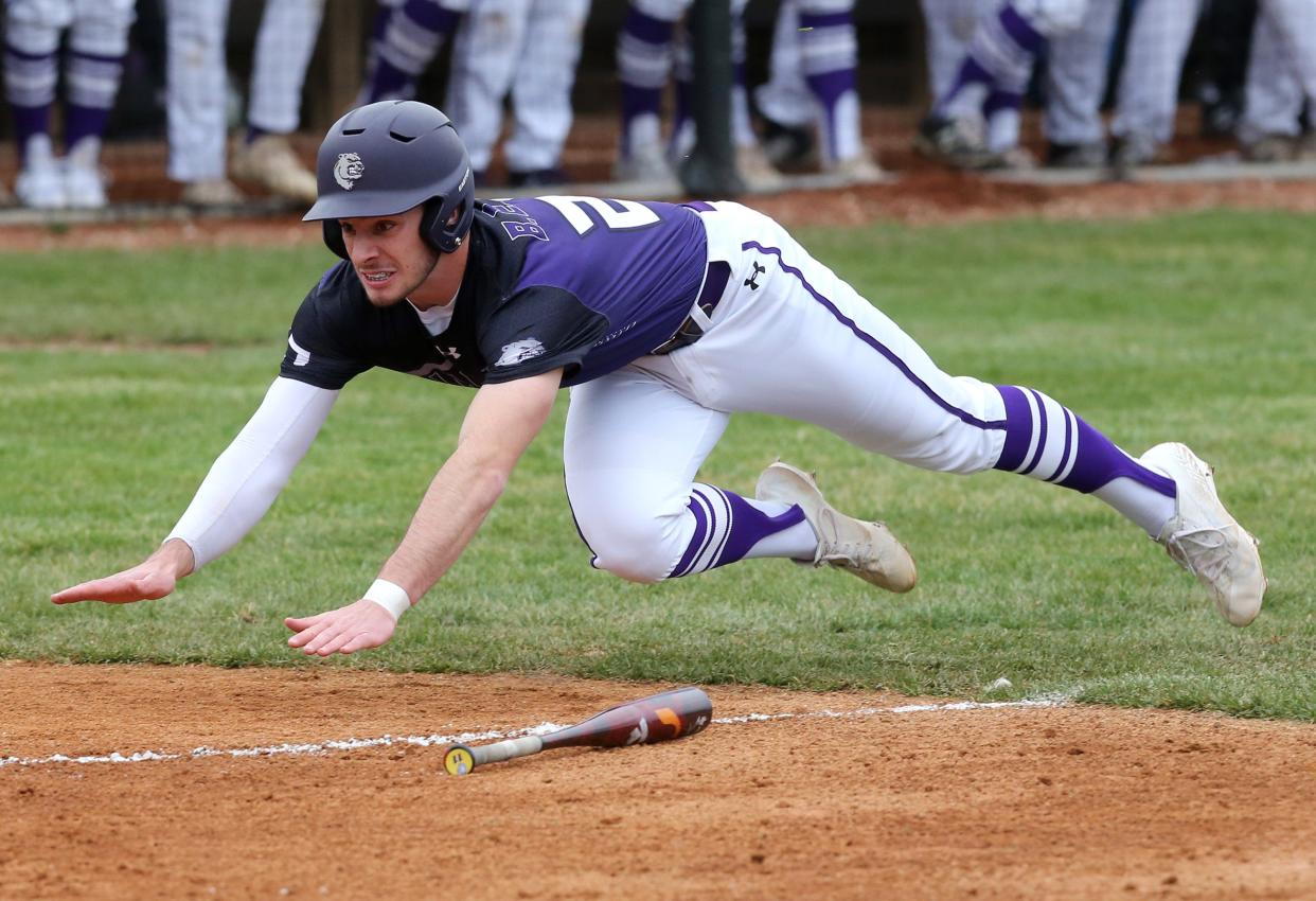 Garrett Wright of Jackson slides safely into home during a win at Hoover on Tuesday, April 5, 2022.