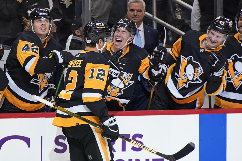 Pittsburgh Penguins' Zach Aston-Reese (12) returns to the bench after scoring during the second period of the team's NHL hockey game against the Vancouver Canucks in Pittsburgh, Wednesday, Nov. 24, 2021. (AP Photo/Gene J. Puskar)