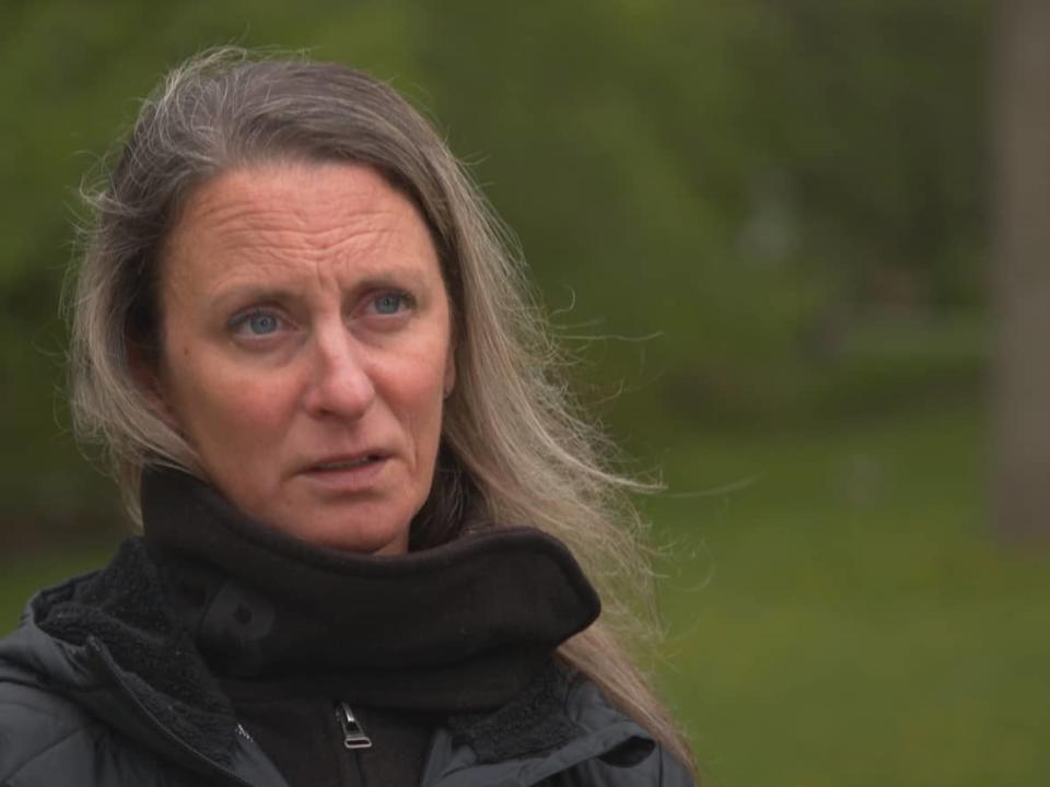 Michelle Snider, a Toronto woman who lives in the Long Branch neighbourhood, is urging people to check themselves and their pets for ticks this year. She is enduring an infestation in her back yard. (CBC - image credit)