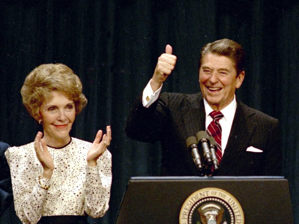 President Ronald Reagan gives a thumbs-up to supporters at the Century Plaza Hotel in Los Angeles as he celebrates his re-election, Nov. 6, 1984, with first lady Nancy Reagan at his side.