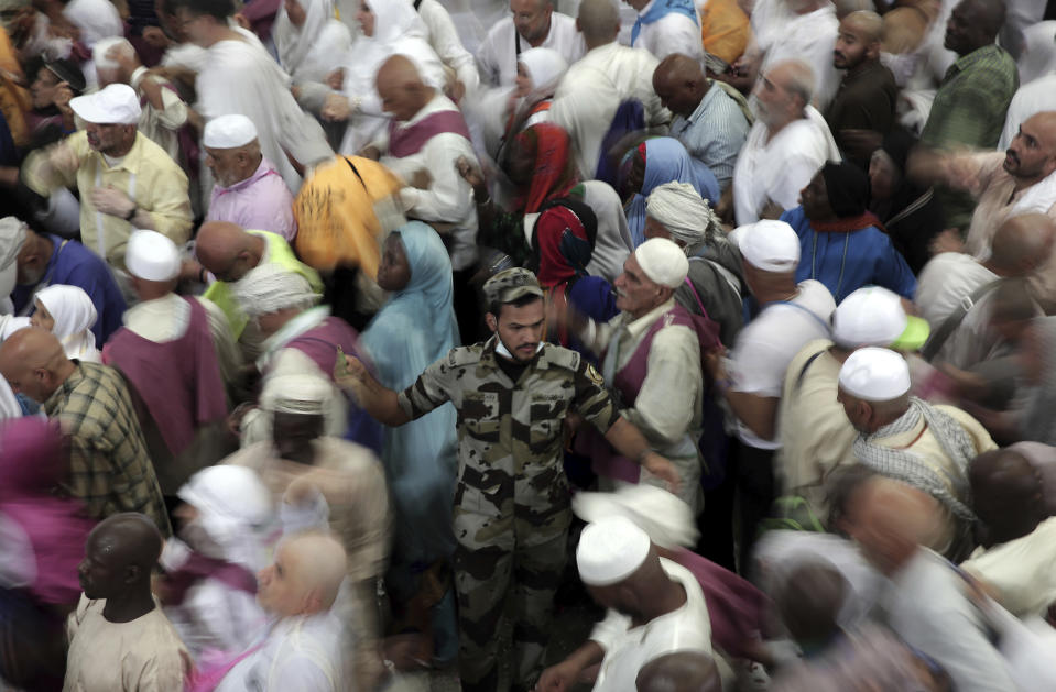 <p>A Saudi security officer controls people as Muslim pilgrims gather to cast stones at three huge stone pillars in the symbolic stoning of the devil, outside the holy city of Mecca, Saudi Arabia, Saturday, Sept. 2, 2017. (Photo: Khalil Hamra/AP) </p>