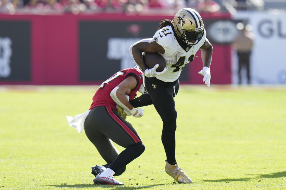 New Orleans Saints running back Alvin Kamara (41) carries against Tampa Bay Buccaneers cornerback Zyon McCollum in the first half of an NFL football game in Tampa, Fla., Sunday, Dec. 31, 2023. (AP Photo/Chris O'Meara)